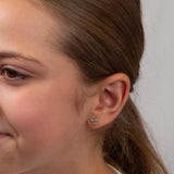 Girl wearing the blue bow Solace flat backs against a plain white background.