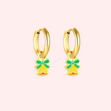 Gold hoop earrings with green and yellow bell charms on a light pink background