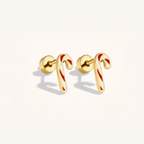 Gold candy cane-shaped earrings with red stripes on a light background