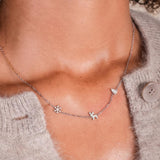 A girl wearing the Christmas Trio Necklace in silver.