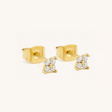 Gold earrings with diamond-like stones on a white background