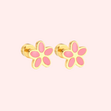 Gold flower-shaped earrings with pink centers on a light pink background