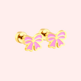Pink bow earrings on a light pink background
