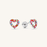 A pair of silver heart stud earrings decorated with small, colorful rhinestones in pink, blue, green, and orange, shown on a light cream background.
