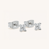 Pair of silver earrings with small diamonds on a white background