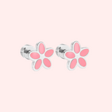 Pink flower-shaped earrings on a light pink background