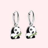 Silver panda hoop earrings on a pink background.