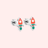 Sliver rocket earrings on a light pink background