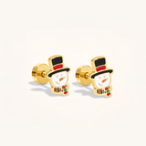 Pair of gold snowman earrings on a light background.