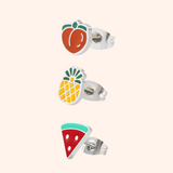 Set of fruit-themed earrings on a light pink background
