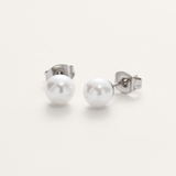 Classic white pearl bead hypoallergenic earrings in silver on white background