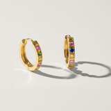 Colourful cubic zirconia hypoallergenic huggie earring in gold on white background