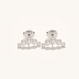 Pair of silver earrings with pearl-like beads on a white background