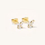 Gold butterfly earrings on a white background
