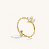 Gold ring with a small floral design on a white background