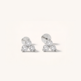 Pair of silver earrings with clear gemstones on a white background.