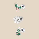A set made up of three silver Christmas themed earrings on a beige background.