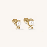 Pair of gold earrings with pearl centers on a white background