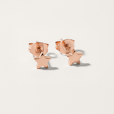 Mini star hypoallergenic earrings in rose gold on white background