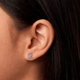 A girl wearing a pair of pink jellyfish flat back earrings.
