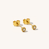 Gold earrings with diamond studs on a white background
