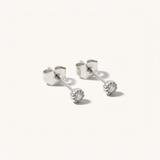 Pair of silver stud earrings with clear gemstones on a white background