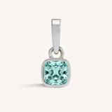 Silver pendant with an aqua gemstone on a white background.