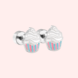Silver cupcake-shaped earrings on a light pink background.