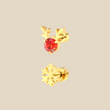 A gold Christmas set with a pair of Rudolph sparkle and snowflake flat back earrings on a beige background.