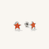 A pair of orange starfish flat back earrings designed for kids.