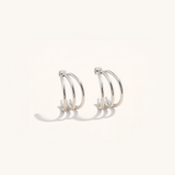 Pair of silver hoop earrings on a white background.