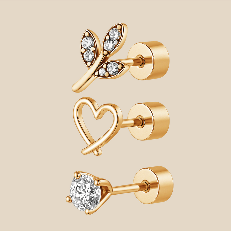 Set of gold earrings with heart, leaf, and round designs on a beige background