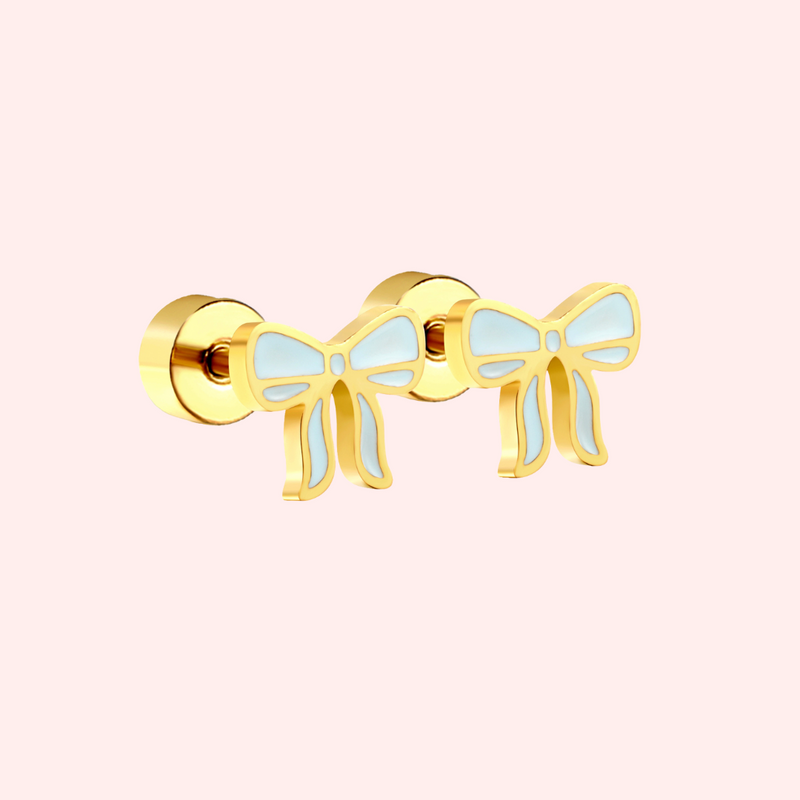 Blue and gold bow earring on a light pink background.