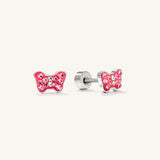 A pair of silver stud earrings shaped like a butterfly, decorated with sparkling pink and clear rhinestones, shown on a clean off-white background.