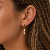 Close-up of model wearing Gold Double Pear Pavé Hoop Earrings with two pear-cut cubic zirconia drops and a crystal pavé huggie hoop