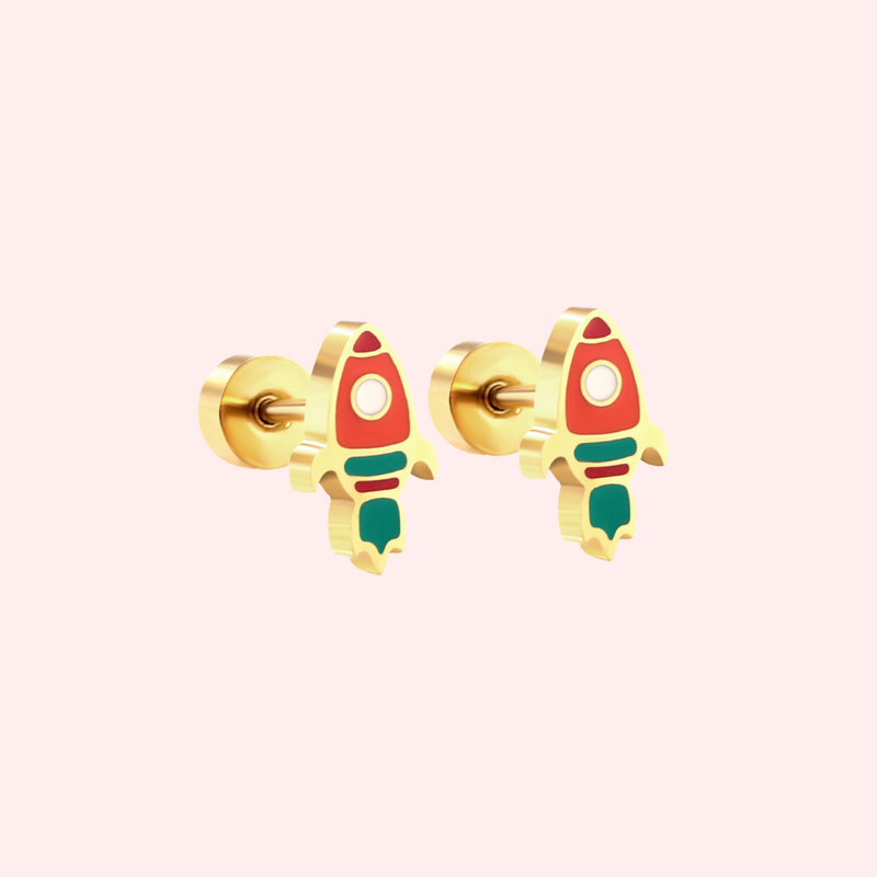 Gold rocket earrings on a light pink background