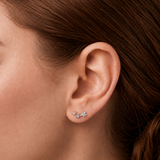 Close-up of model wearing Silver Celestial Trio Flat Back Earrings with three star-shaped details and clear cubic zirconia stones