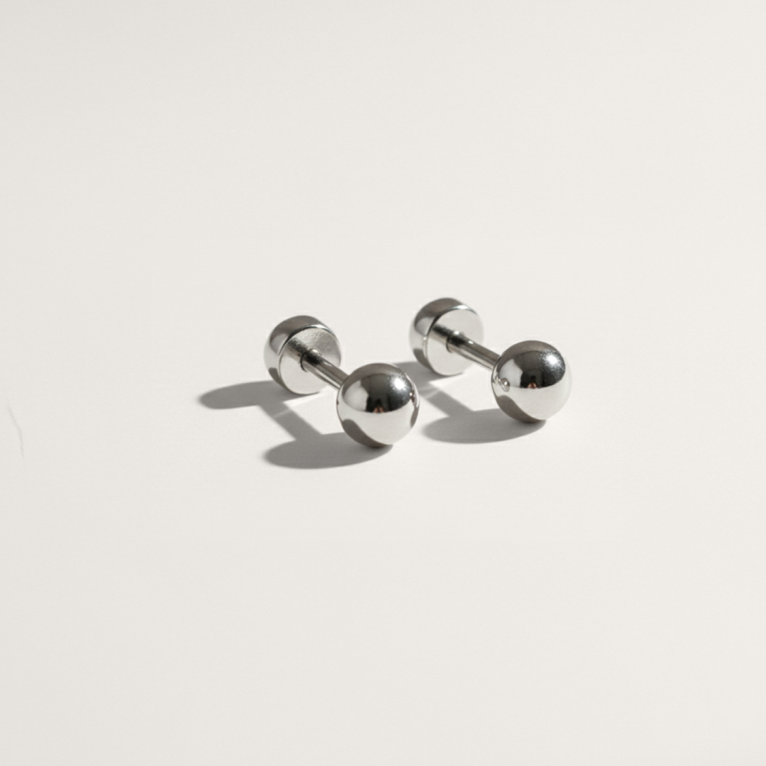Ball hypoallergenic flat back stud earring in silver on white background