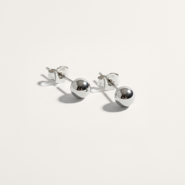 Ball hypoallergenic stud earrings in silver on white background
