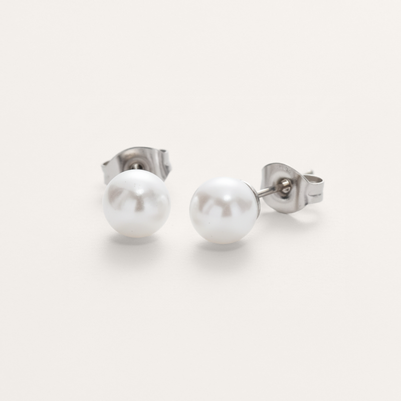 Classic white pearl bead hypoallergenic earrings in silver on white background