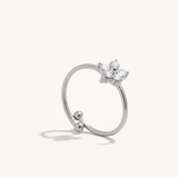 Silver ring with a flower on a white background