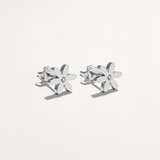 Silver flower-shaped earrings on a white background