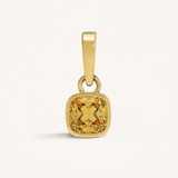 Gold pendant with a yellow gemstone on a white background