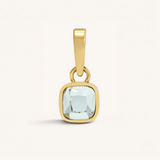 Gold pendant with a clear gemstone on a white background