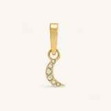 Gold pendant with embedded stones on a white background