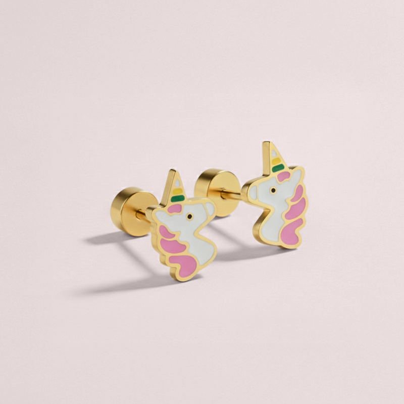 Unicorn-shaped earrings on a light pink background