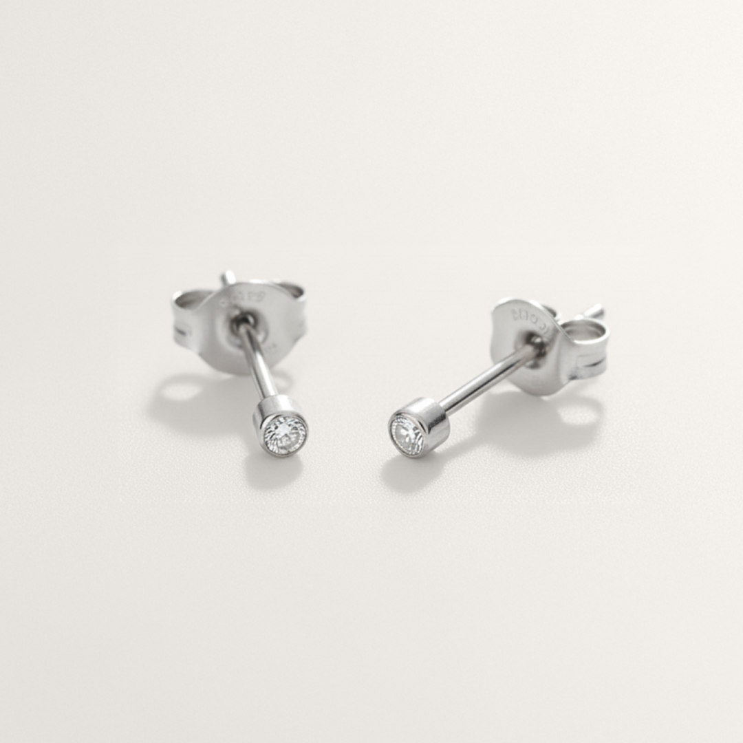Mini CZ hypoallergenic stud earrings in silver on white background