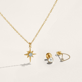 Gold necklace with star pendant and matching earrings on a light beige background