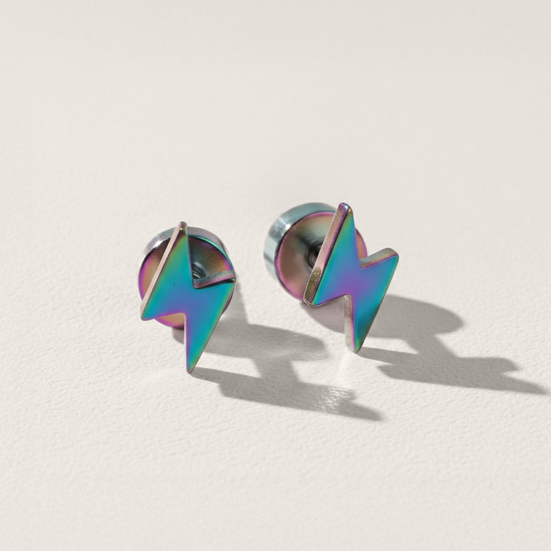 Pair of colorful lightning bolt-shaped earrings on a light beige background