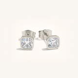 Pair of silver stud earrings with clear gemstones on a white background